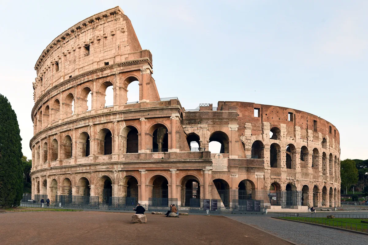 The Colosseum in Rome seen from the south-west, with its three tiers of arches, the tall outer wall on the left and the broken outer wall on the right