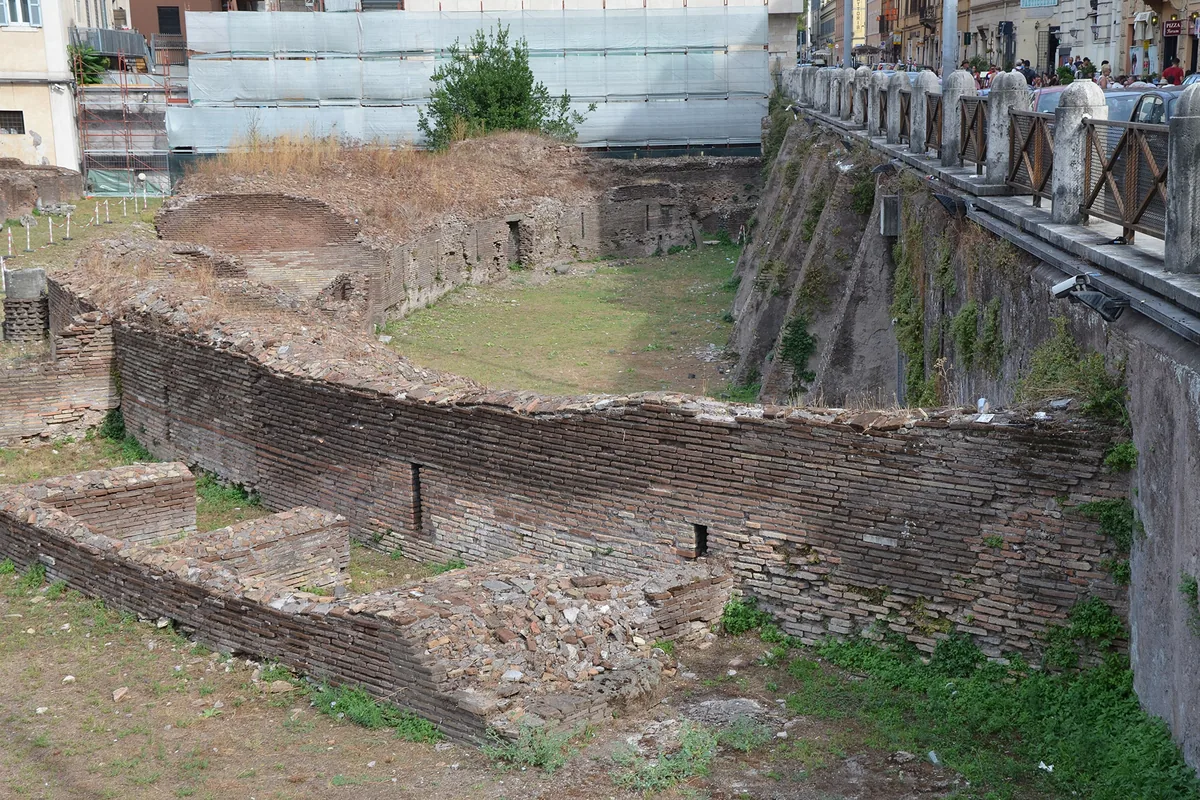 The ruins of the Ludus Magnus beside the Colosseum, an oval of brick walls around a sunken space